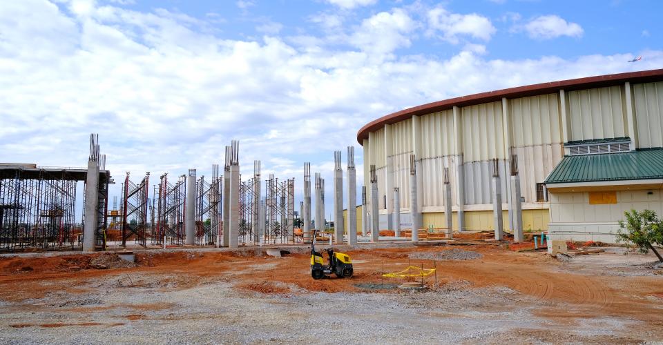 Under construction at the OKC Fairgrounds, the beginnings of a new coliseum rises on Monday above the ground next to the aging Jim Norick Arena as crews start setting up for the 2023 Oklahoma State Fair.