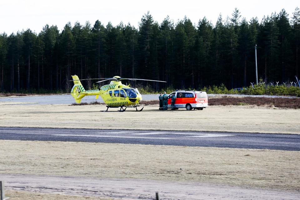 A helicopter and an ambulance are seen at the Jamijarvi Airfield, southwest Finland, on Sunday April 20, 2014. A small passenger plane carrying parachuters fell to the ground near the airfield on Sunday afternoon. The police say that there are more than three victims. Three people out of 11 on the plane were rescued. (AP Photo/Mika Kanerva, Lehtikuva) FINLAND OUT