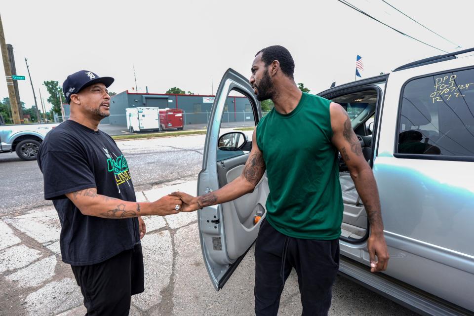 Phillip Sample, left, shakes hands with Dondre Knight, 30, of Detroit, after Sample, with the 4820Live Peace Initiative, paid $245 to get Knight's vehicle out of impound in Detroit on Tuesday, July 9, 2024. Knight says that between him and his girlfriend they called 911 seven times to complain about the illegal block party that had spilled out onto his street, before the shooting had begun early Sunday morning. When he left to go to the store after police tape was up, he was not allowed to go back home and got into an argument with police and was arrested and his vehicle was impounded. He was released 20 minutes later, but wasn't able to get his vehicle until Tuesday with the help of 4820Live Peace Initiative. Kimberly P. Mitchell, Detroit Free Press
