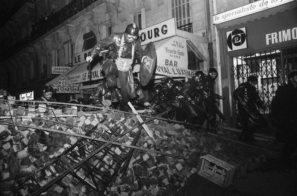 <p>CRS riot police wielding shields and batons cross a barricade to charge striking students near the Sorbonne in Paris on May 10, 1968. (Photo: Gökşin Sipahioğlu/SIPA) </p>