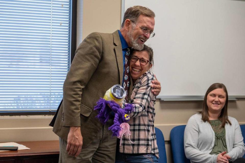 Darrell Missey presented a yarn doll to Laura Jerabak during a meeting at the Department of Social Services office in Raymore. Missey makes the dolls and gives them to employees who go above and beyond their work duties.