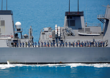 Crew members of Japanese destroyer Suzutsuki wave to Japanese helicopter carrier Kaga after their joint naval drill with Indonesian patrol boat Kurau in the Indian Ocean, Indonesia September 22, 2018. Picture taken September 22, 2018. REUTERS/Kim Kyung-Hoon