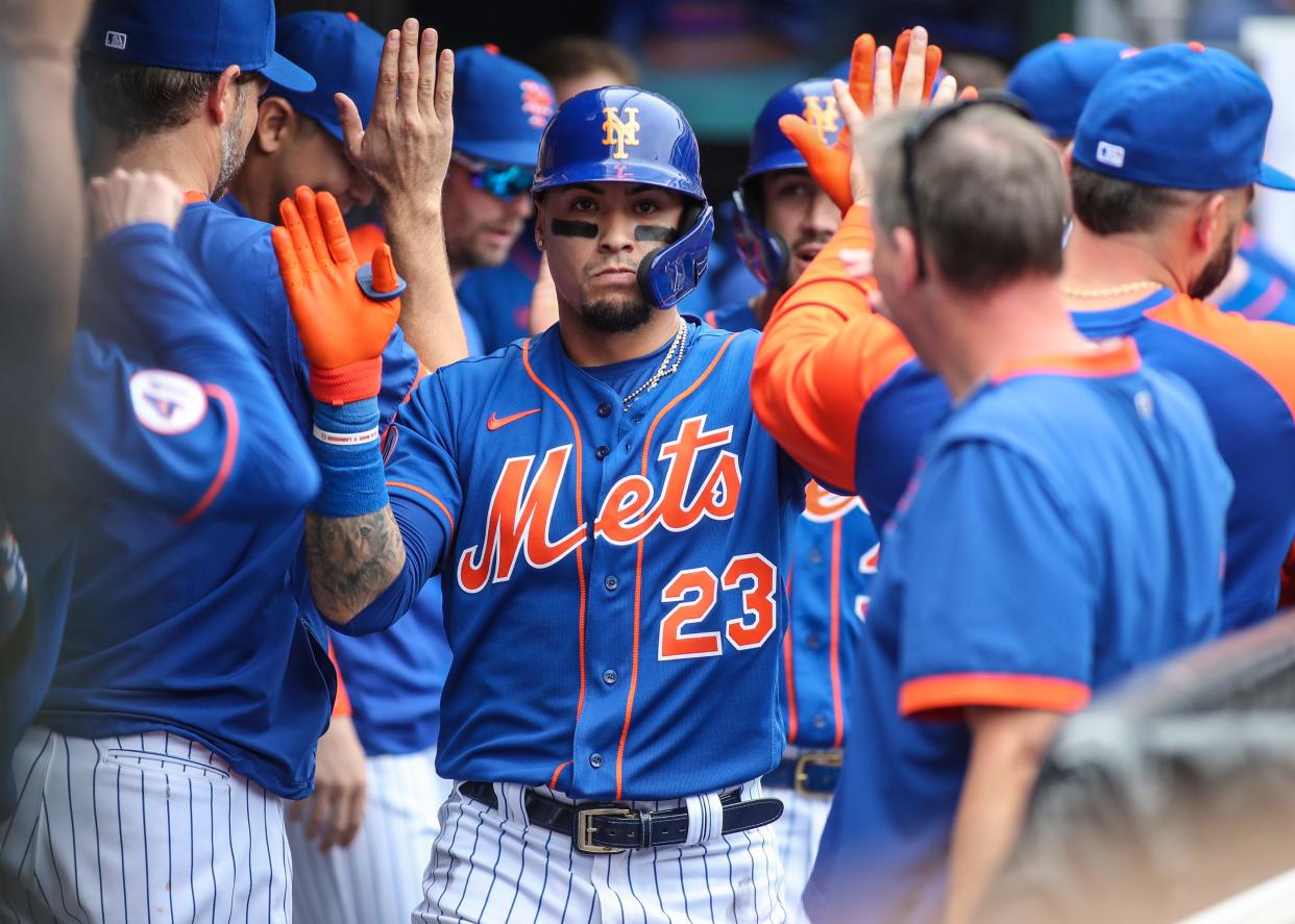 Aug 29, 2021; New York City, New York, USA;  New York Mets second baseman Javier Baez (23) is greeted in the dugout after hitting a two run home run in the fourth inning against the Washington Nationals at Citi Field. Mandatory Credit: Wendell Cruz-USA TODAY Sports