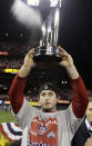 FILE - In this Oct. 28, 2011, file photo, St. Louis Cardinals' David Freese holds up the MVP trophy after Game 7 of baseball's World Series against the Texas Rangers in St. Louis. Freese is retiring after a 10-year career that included a World Series title in 2011 with the St. Louis Cardinals when he was MVP. The 36-year-old infielder made the announcement Saturday, Oct. 12, 2019, on his verified Twitter account. (AP Photo/Charlie Riedel< File)