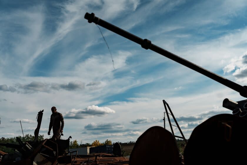 IZIUM, UKRAINE - SEPTEMBER 22: A military man stands on wreckage of Russian military vehicles, destroyed by Ukrainian Forces during a counteroffensive in Kharkiv Oblast, on September 22, 2022 in Izium, Ukraine. Almost 70% of high-rise buildings in Izium, Kharkiv Oblast were damaged, according to local authorities. Gas, electricity and water are currently missing in most areas of the city. Communal communities and rescuers are working on restoration. Locals began to go to the city center after Ukrainian military begun patrolling the streets and reported that it was safe to be in the city. (Photo by Serhii Mykhalchuk/Global Images Ukraine via Getty Images)