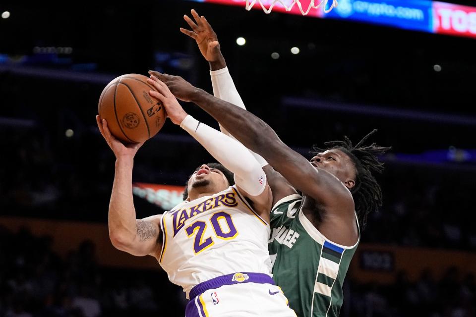Los Angeles Lakers guard Scotty Pippen Jr., left, shoots as Milwaukee Bucks forward Chris Livingston defends Oct. 15, 2023, in Los Angeles.