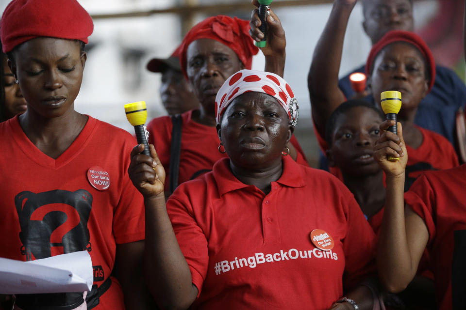 Bring back our girls campaigners hold Torchlights during a vigil to mark three years anniversary of the abduction of girls studying at the Chibok government secondary school in Lagos, Nigeria Friday, April. 14, 2017. Nigerians on Friday marked three years since the mass abduction of nearly 300 schoolgirls by Boko Haram extremists amid anger that government efforts to negotiate their freedom appear to have stalled. (AP Photo/ Sunday Alamba)