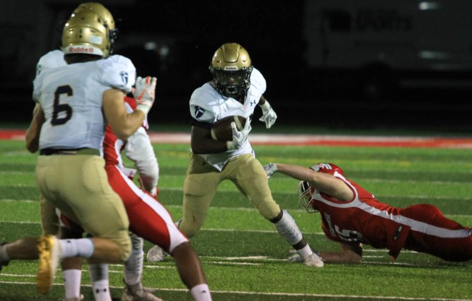 St. Thomas Aquinas running back Tank Young tried to work his way down field against Bishop Miege on Friday night.