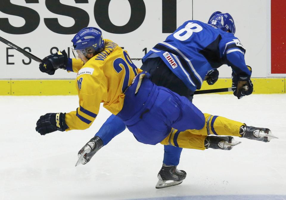 Sweden's Lucas Wallmark (L) is checked by Finland's Saku Kinnunen during the third period of their IIHF World Junior Championship gold medal ice hockey game in Malmo, Sweden, January 5, 2014. REUTERS/Alexander Demianchuk (SWEDEN - Tags: SPORT ICE HOCKEY)