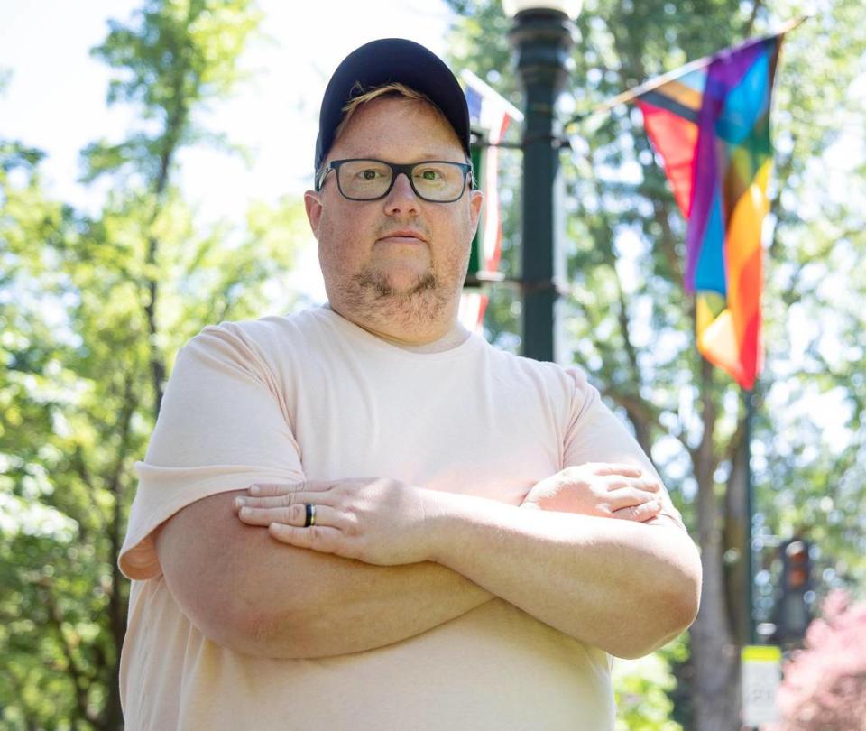 Boise Pride Festival Vice President Joe Kibbe wears his engagement ring by a pride flag along Harrison Blvd. in Boise on Friday June 18, 2021. On Friday Kibbe was engaged to his boyfriend, but he also found out that over 20 LGBTQ pride flags his organization had displayed for pride month had been stolen.