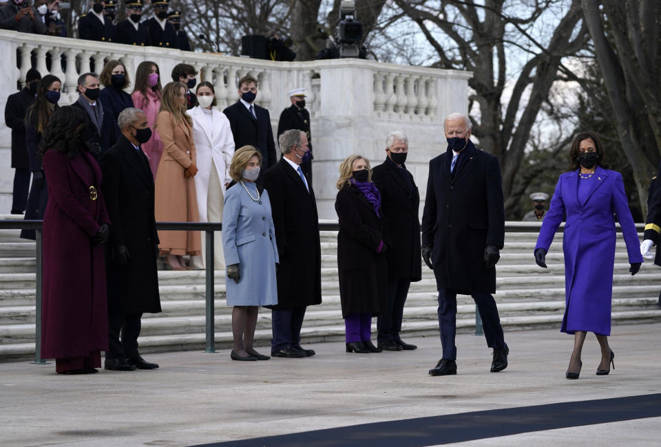 President Joe Biden and Vice President Kamala Harris arrive at the Tomb of the Unknown Soldier at Arlington National Cemetery during Inauguration Day ceremonies in Arlington, Va. Former President Barack Obama and his wife Michelle, former President George W. Bush and his wife Laura and former President Bill Clinton and his wife former Secretary of State Hillary Clinton and family look on. (AP Photo/Evan Vucci)