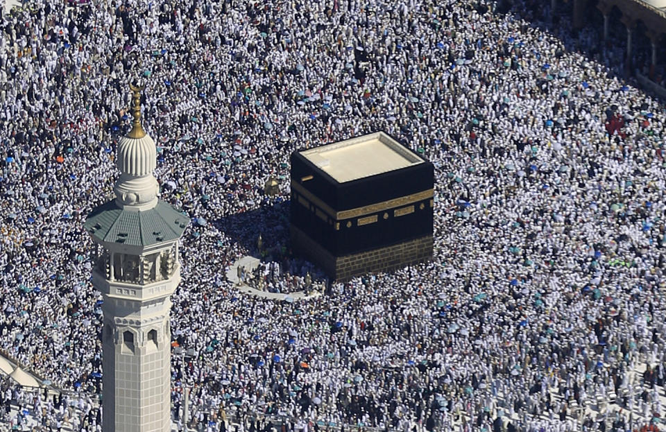 FILE - This Nov. 7, 2011 file photo, made from a helicopter, shows Muslim pilgrims moving around the Kaaba, the black cube seen at center, inside the Grand Mosque, during the annual Hajj in the Saudi holy city of Mecca, Saudi Arabia. Muslims do not worship the Kaaba, but it is Islam's most sacred site because it represents the metaphorical house of God and the oneness of God in Islam. Observant Muslims around the world face toward the Kaaba during their five daily prayers. (AP Photo/Hassan Ammar, File)