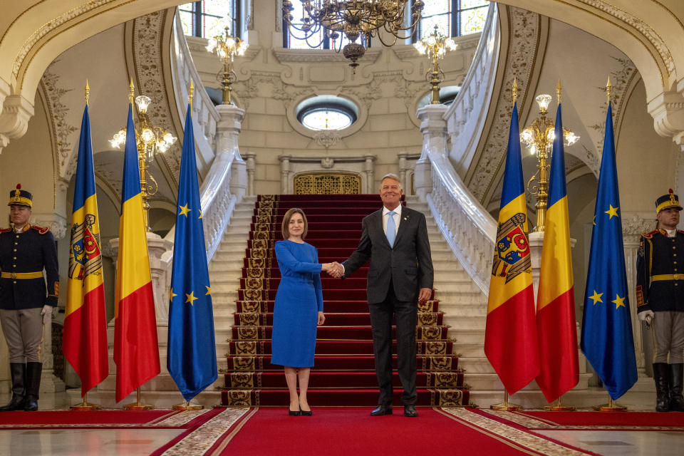 Romania's President Klaus Iohannis, right, shakes hands with Moldova's President Maia Sandu at the Cotroceni Presidential Palace in Bucharest, Romania, Wednesday, Sept. 6, 2023. Romania hosts the two-day Three Seas Initiative Summit and Business Forum, bringing together high ranking officials from twelve EU member states between the Baltic, Black and Adriatic seas. (AP Photo/Vadim Ghirda)