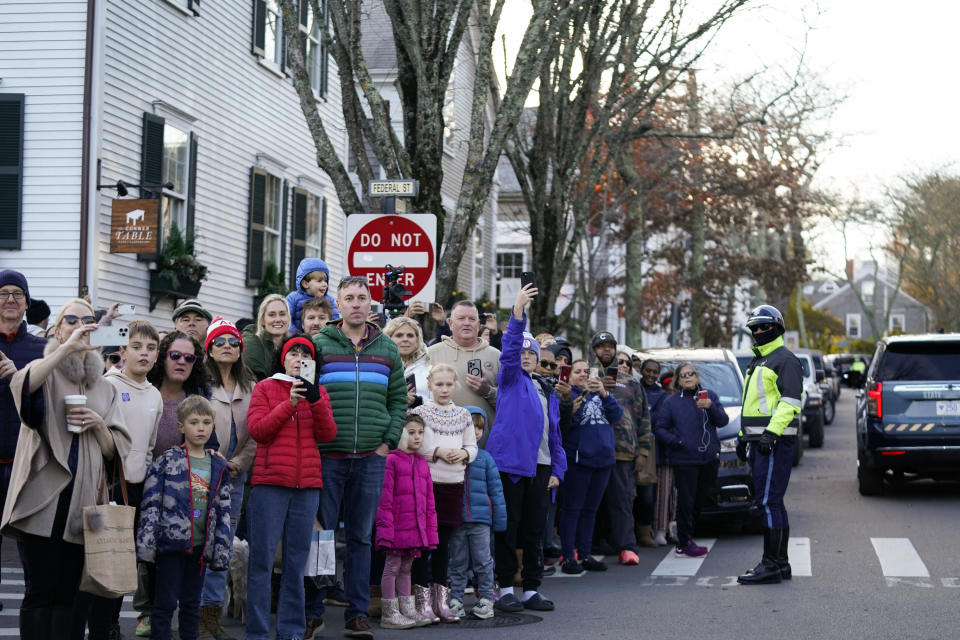 People watch as President Joe Biden and first lady Jill Biden visit shops in Nantucket, Mass., Friday, Nov. 24, 2023. (AP Photo/Stephanie Scarbrough)