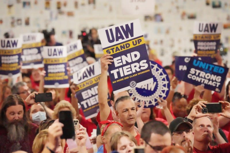 Striking United Auto Workers hold up signs in solidarity as they listen to Rep. Cory Bush, D-St. Louis, and Rep. Alexandria Ocasio-Cortez, D-N.Y., during a rally in Wentzville, Mo., in September. File Photo by Bill Greenblatt/UPI