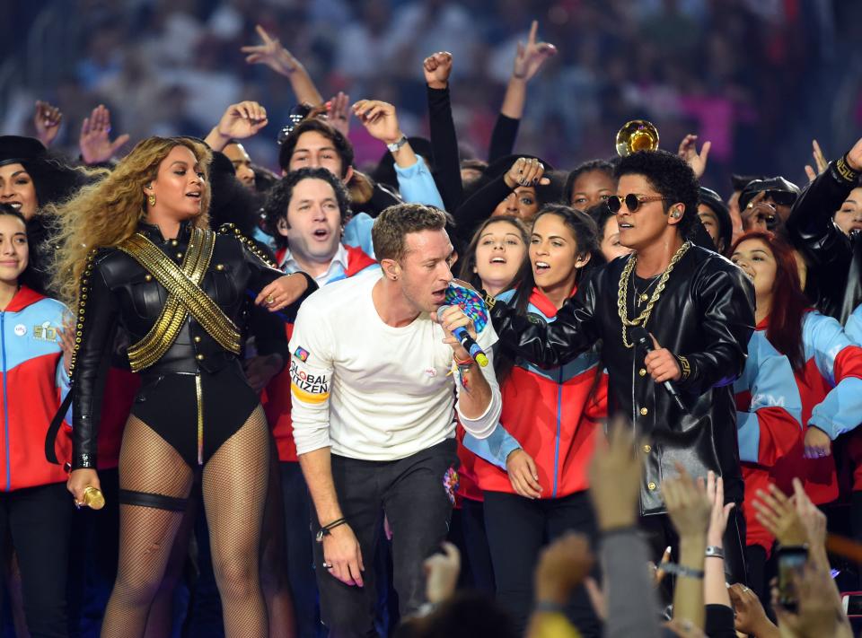 Coldplay singer Chris Martin (center), recording artist Beyonce (left), and recording artist Bruno Mars perform during halftime between the Carolina Panthers and the Denver Broncos in Super Bowl 50 at Levi's Stadium.