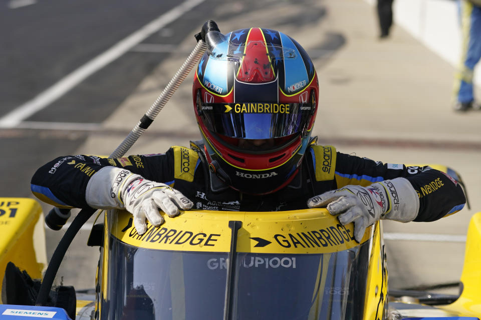 Colton Herta climbs out of his car during practice for the Indianapolis 500 auto race at Indianapolis Motor Speedway, Tuesday, May 17, 2022, in Indianapolis. (AP Photo/Darron Cummings)