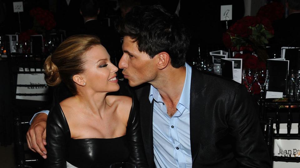 Andres Velencoso going in to kiss Kylie Minogue