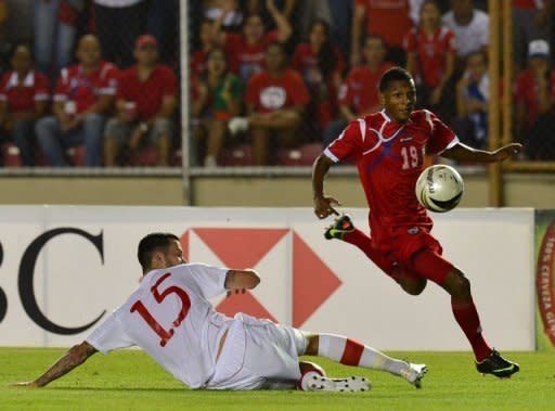 Panama's Alberto Quintero (R) kicks the ball past Canada's David Edgar during their World Cup CONCACAF qualifying match on September 11. Panama beat Canada 2-0 and Honduras blanked Cuba 1-0