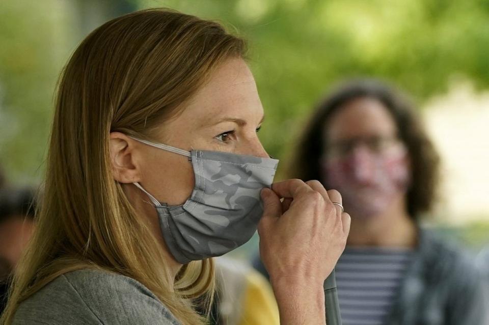 In this Sept. 19, 2020, file photo, Missouri State Auditor and Democratic gubernatorial candidate Nicole Galloway adjusts her face mask as she addresses the crowd during a campaign stop Saturday, Sept. 19, 2020, in Kansas City, Mo. (AP Photo/Charlie Riedel)