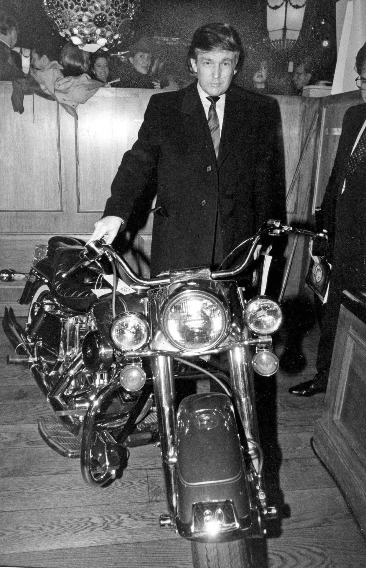 Donald Trump poses with a 1980 Harley-Davidson motorcycle once owned by Arnold Schwarzenegger at Maxwell's Plum restaurant on New York's Upper East Side, on Jan. 13, 1989.