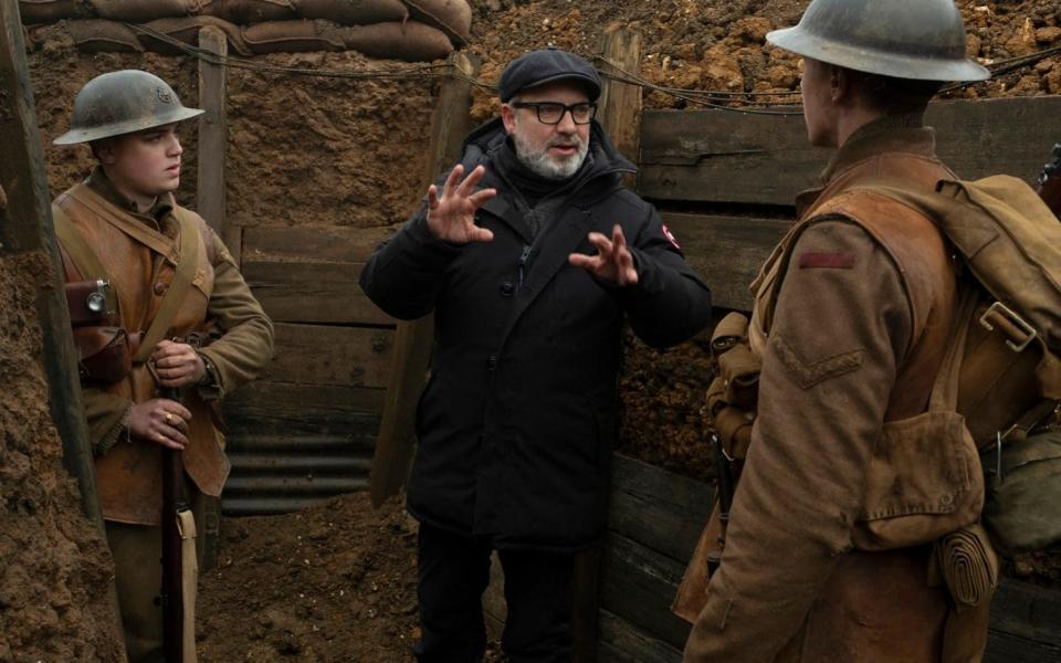 Dean-Charles Chapman, left, director Sam Mendes, center, and George MacKay on the set of 1917 - universal