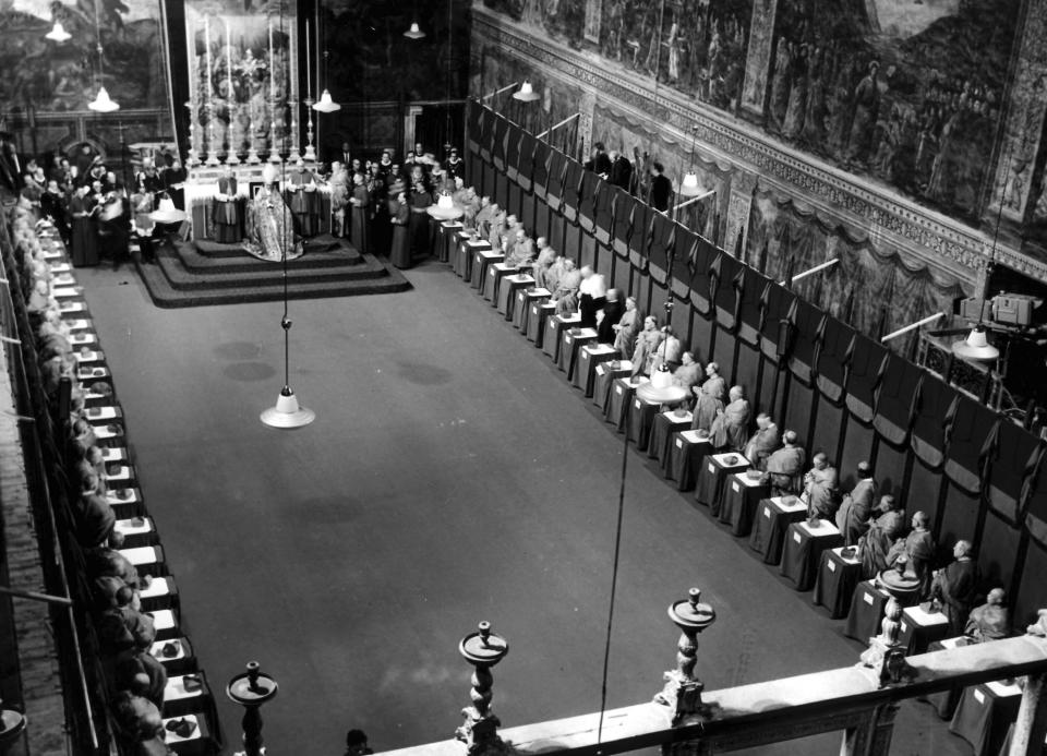 FILE - Pope Paul VI sits on his throne before the altar in far background in the Sistine Chapel of the Vatican, as he delivers his first message to the world June 22, 1963, the day after he was elected Pontiff. 79 Cardinals are standing left and right at the seats and tables where they sat during the Conclave that elected Pope Paul VI. At the Pope's right stands Msgr. Enrico Dante, Prefect of the Pontific Ceremonies, and at his left side Msgr. Salvatore Capoferri, Master of the Pontific Ceremonies. (AP Photo/Luigi Felici, File)