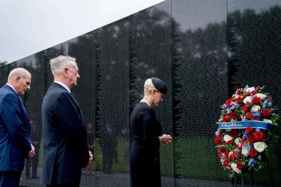 16) Cindy McCain places a wreath at the Vietnam Veterans Memorial.
