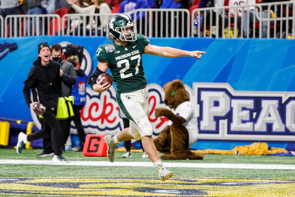 Michigan State linebacker Cal Haladay scores a touchdown after intercepting the ball from Pittsburgh quarterback Davis Beville during the second half of the 31-21 win over Pittsburgh in the Peach Bowl at the Mercedes-Benz Stadium in Atlanta on Thursday, Dec. 30, 2021.