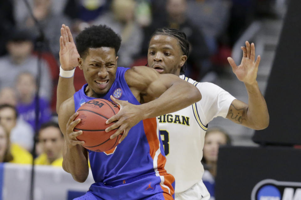 <p>Florida’s KeVaughn Allen (5) is guarded by Michigan’s Zavier Simpson, right, during the first half of a second round men’s college basketball game in the NCAA Tournament, in Des Moines, Iowa, Saturday, March 23, 2019. (AP Photo/Nati Harnik) </p>