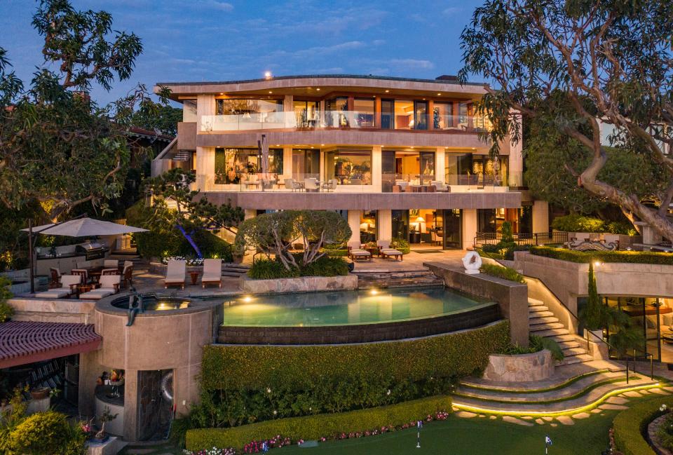 The putting lawn is woven into the garden at the expansive Orange County dwelling.