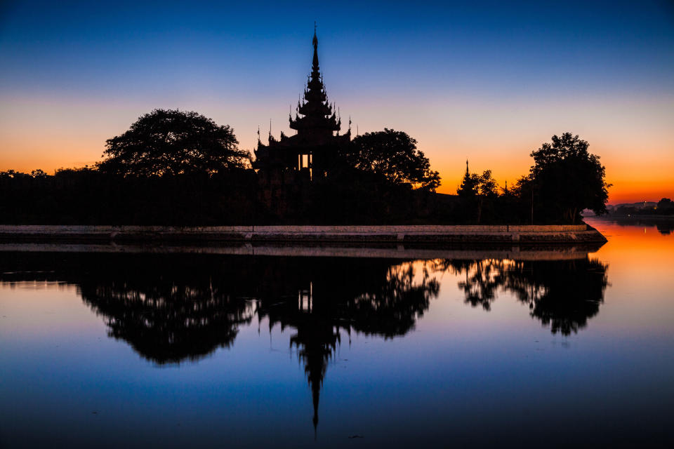 In this December 2012 photo Mandalay Palace is reflected in a surrounding moat, in Mandalay, Myanmar. (AP Photo/Richard Camp)