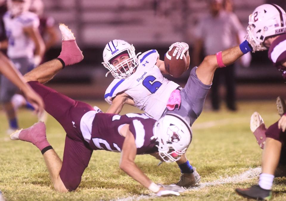 Hawley's Tate Scott upends Winters' Chris Martinez on a running play in the third quarter. Hawley beat the Blizzards 48-12 in the District 4-2A Division I game Thursday, Oct. 12, 2023, at Forrest Field in Hawley.
