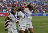 From left: United States' Kelley O Hara, United States' Alex Morgan and United States' Allie Long celebrate their victory in the Women's World Cup final soccer match between US and The Netherlands at the Stade de Lyon in Decines, outside Lyon, France, Sunday, July 7, 2019. US won 2:0. (AP Photo/David Vincent)