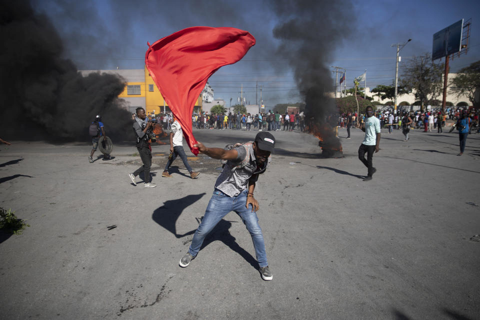 Factory workers protest to demand a salary increase in Port-au-Prince, Haiti, Wednesday, Feb. 23, 2022. It is the first day of a three-day strike organized by factory workers who also shut down an industrial park earlier this month to protest pay. (AP Photo/Odelyn Joseph)