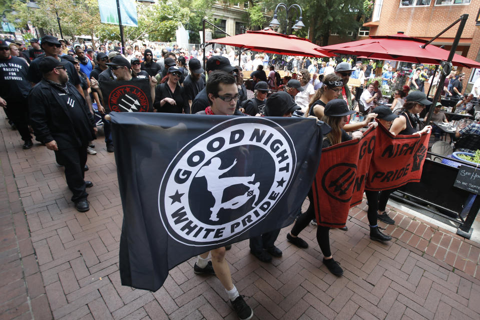 A group anti-fascism demonstrators march in the downtown area in anticipation of the anniversary of last year's Unite the Right rally in Charlottesville, Va., Saturday, Aug. 11, 2018. (AP Photo/Steve Helber)