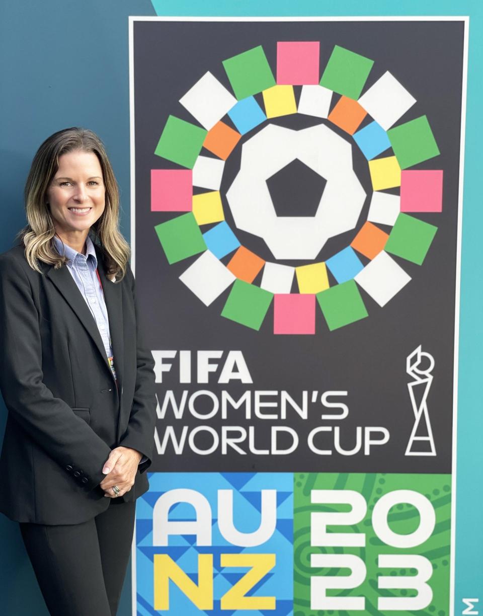 Kaley Diaz of the U.S. Department of State’s Diplomatic Security Service poses next to the 2023 FIFA Women's World Cup banner.