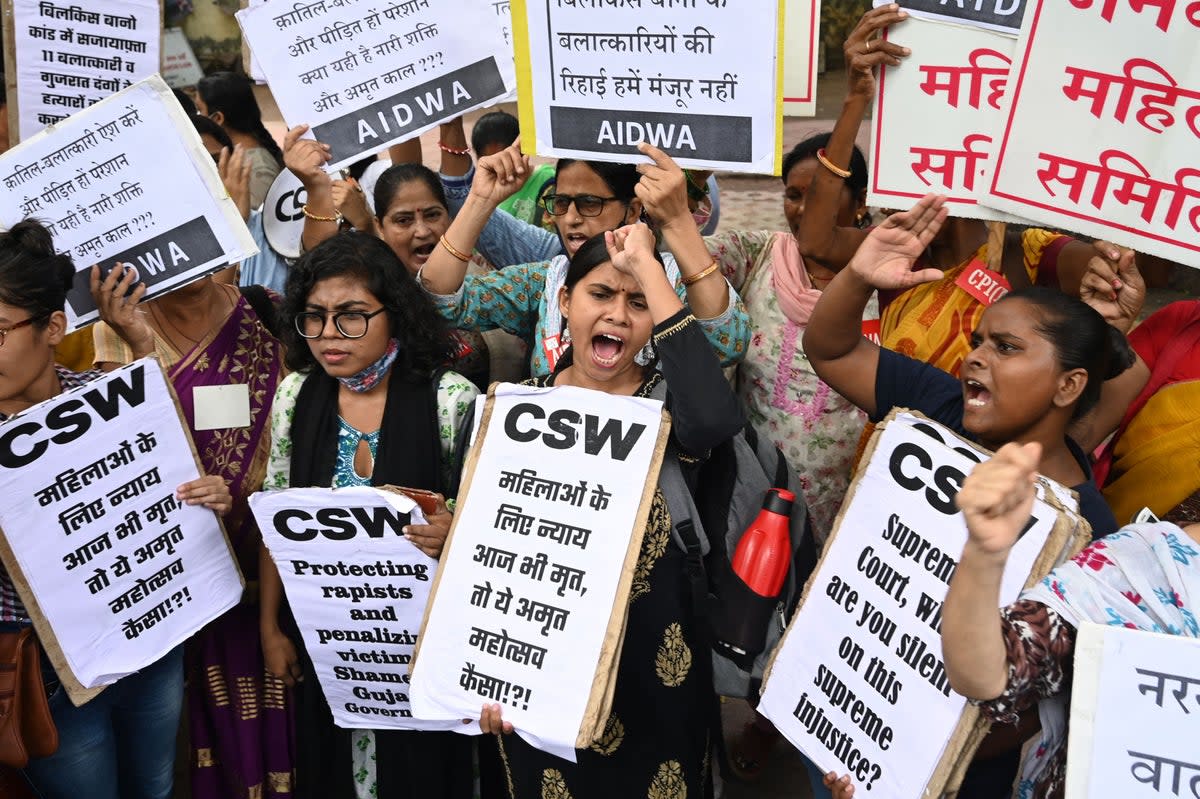 Activists shout slogans and hold placards during a protest against the release, following a recommendation by a Gujarat's state government panel (AFP via Getty Images)