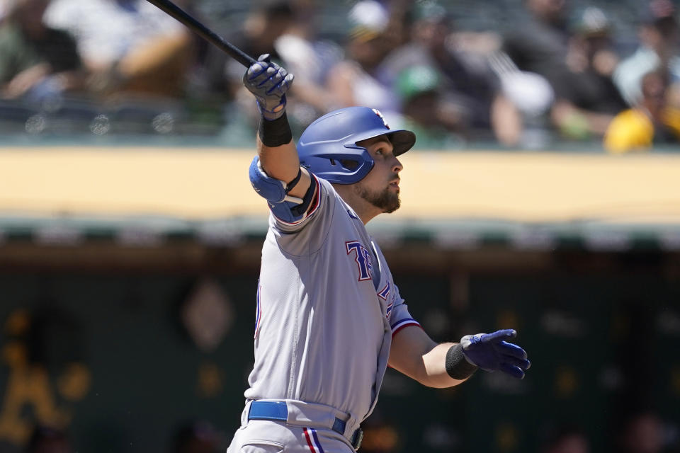 Texas Rangers' Nate Lowe watches his two-run home run during the seventh inning of a baseball game against the Oakland Athletics in Oakland, Calif., Thursday, July 1, 2021. (AP Photo/Jeff Chiu)