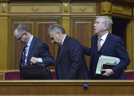Former Polish President Aleksander Kwasniewski and former European Parliament President Pat Cox (R) leave a session of the Parliament in Kiev November 13, 2013. REUTERS/Stringer