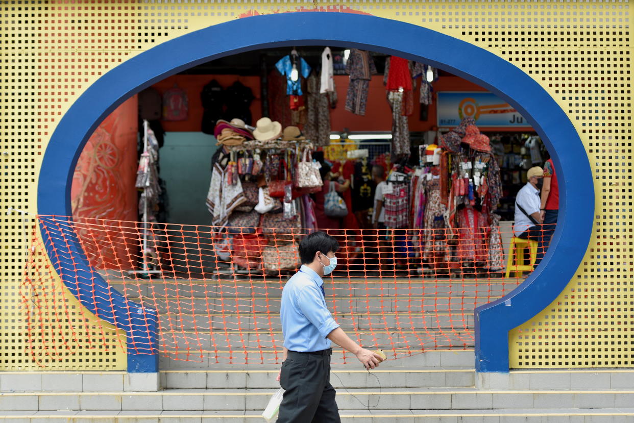 A man walks past a cordoned-off entrance, amidst the coronavirus disease (COVID-19) pandemic, in Singapore November 3, 2021. REUTERS/Caroline Chia