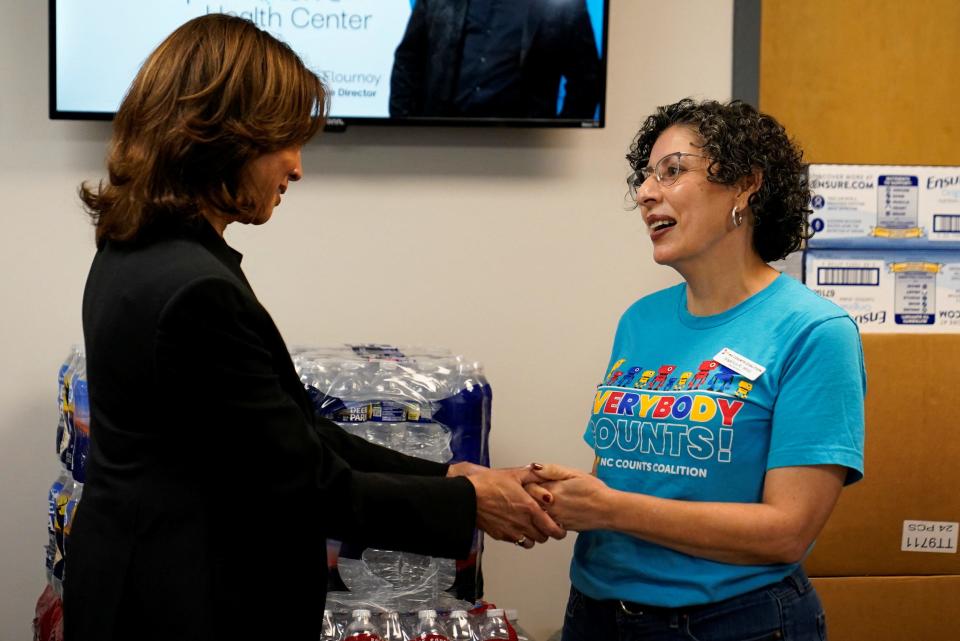 Vice President Kamala Harris, the Democratic presidential nominee, speaks with Angelica Wind of Asheville as she meets with volunteers assembling emergency aid packages at a resource donation center in Charlotte on Saturday.