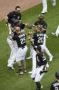 Chicago White Sox's Jose Abreu (79) celebrates with teammates after sliding into home plate safely on a wild pitch to defeat the Kansas City Royals in a baseball game Sunday, May 16, 2021, in Chicago. (AP Photo/Paul Beaty)