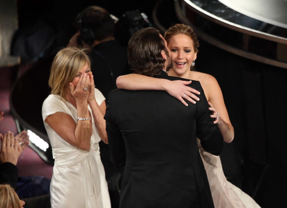 Jennifer Lawrence, mother Karen Lawrence and actor Bradley Cooper celebrate after Lawrence wins the Best Actress award for 'Silver Linings Playbook' onstage during the Oscars held at the Dolby Theatre on February 24, 2013 in Hollywood, California.