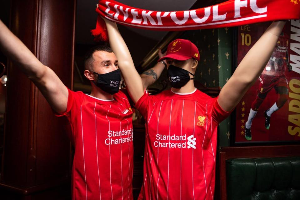 A Liverpool fan poses with a manikin inside Anfield sports bar (Kim Sengupta)