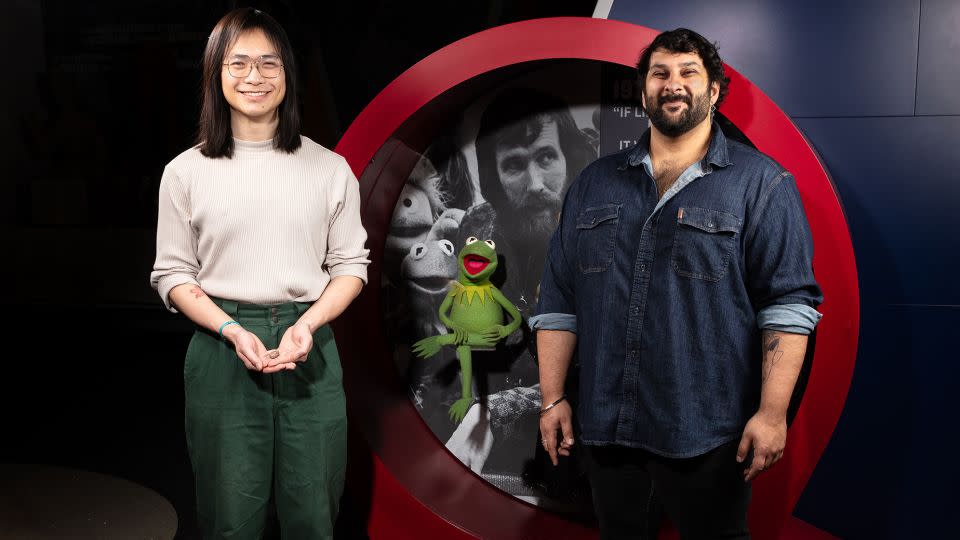 The new paper's authors, Calvin So (left) and Arjan Mann (right), named the prehistoric amphibians after Kermit the Frog.  The Muppet icon was photographed in the Entertainment Nation exhibit at the Smithsonian National Museum of American History.  -Courtesy of James D. Tiller/James D. Loreto/Smithsonian National Museum of Natural History