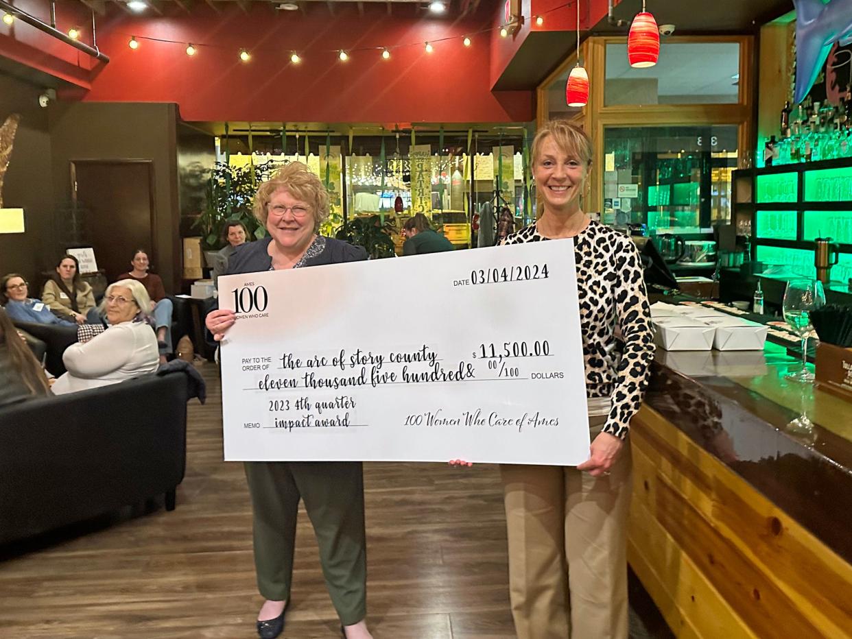 Brenda Dryer, left, Arc of Story County's board president, and Tricia Crain, Arc's executive director, accept $11,500 from 100 Women Who Care during a meeting at Della Viti March 4. The Ames chapter of the charitable group voted at its fourth quarter meeting in 2023 to offer the Impact Award to Arc, which also received an additional $5,000 matching donation from Best Buy Foundation.