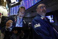 Trader Gregory Rowe, left, and specialist Peter Giacchi work on the floor of the New York Stock Exchange, Thursday, July 18, 2019. U.S. stocks moved lower in early trading on Wall Street Thursday after Netflix reported a slump in new subscribers and dragged down communications companies. (AP Photo/Richard Drew)