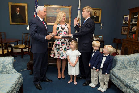 Nick Ayers is being sworn-in by Vice President Mike Pence (L), as his Chief of Staff with his wife Jamie Floyd and children in attendance, in this social media photo released by Vice President's office in Washington, DC, U.S., on July 28, 2017. Courtesy Vice President's office/Handout via REUTERS