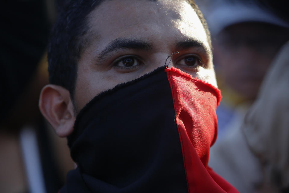 A follower of President Daniel Ortega, with a Sandinista colors bandana over his face, attends a rally in Managua, Nicaragua, Wednesday, Sept. 5, 2018. The United States warned the Security Council on Wednesday that Nicaragua is heading down the path that led to conflict in Syria and a crisis in Venezuela that has spilled into the region, but Russia, China and Bolivia said Nicaragua doesn't pose an international threat and the U.N. should butt out. (AP Photo/Alfredo Zuniga)